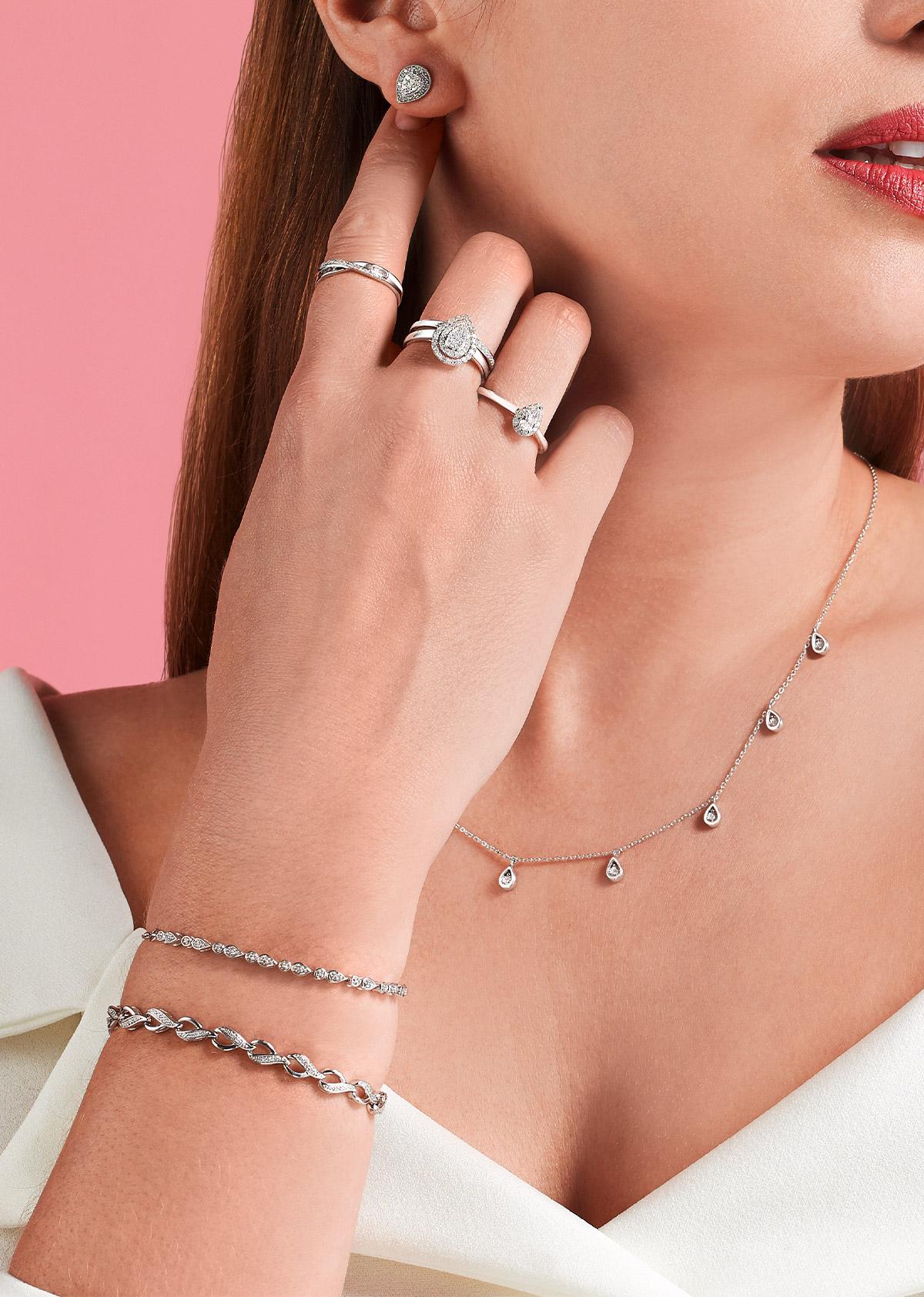 How Your Jewellery Spells Out Your Vibe? Lady wearing diamond rings, earrings, tennis bracelets and necklace.